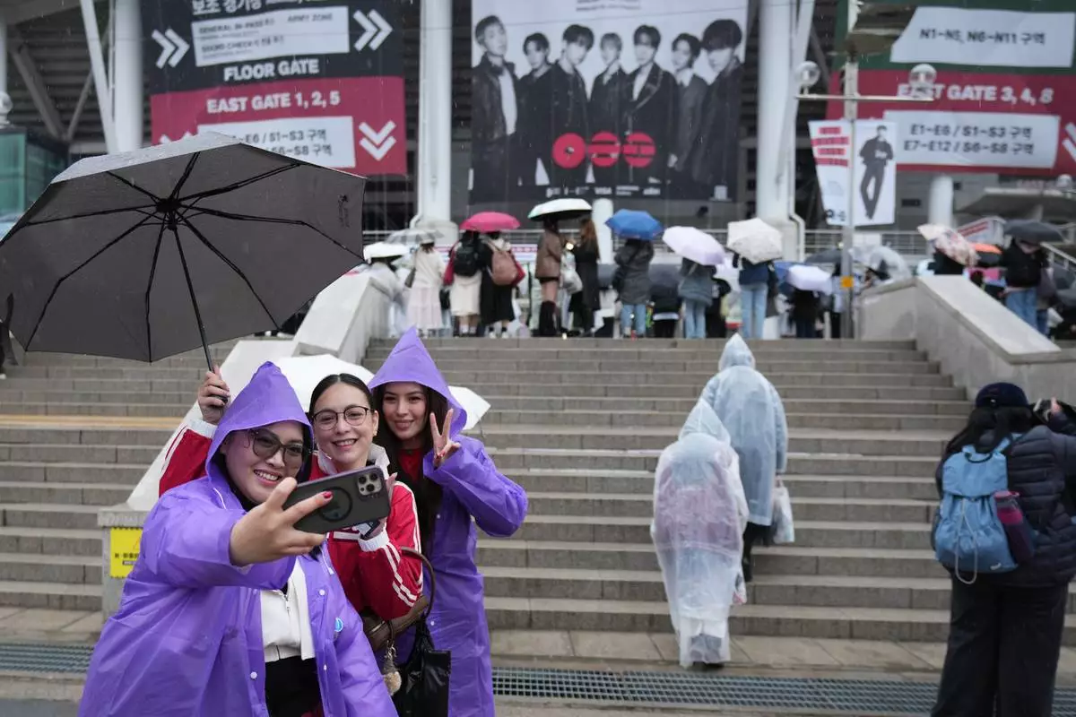 K-pop band BTS fans from Philippines take a souvenir photo at the venue for the BTS World Tour Arirang in Goyang, South Korea, Thursday, April 9, 2026. (AP Photo/Lee Jin-man)