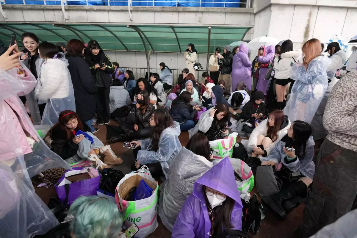 Fans of K-pop band BTS wait for the BTS World Tour Arirang outside of the venue in Goyang, South Korea, Thursday, April 9, 2026. (AP Photo/Lee Jin-man)