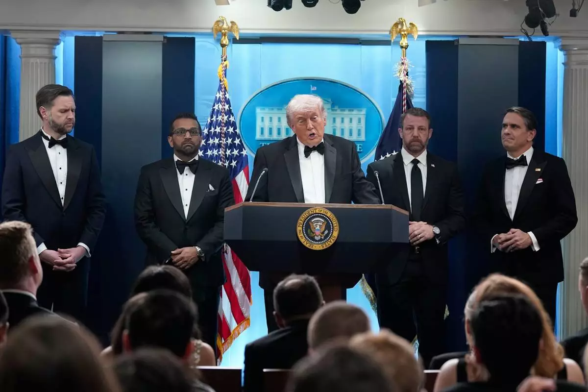 President Donald Trump speaks in the James Brady Press Briefing Room at the White House after an unspecified threat at the annual White House Correspondents' Association Dinner in Washington, Saturday, April 25, 2026, as Vice President JD Vance, FBI director Kash Patel, Homeland Security Secretary Markwayne Mullin and acting Attorney General Todd Blanche listen. (AP Photo/Jose Luis Magana)