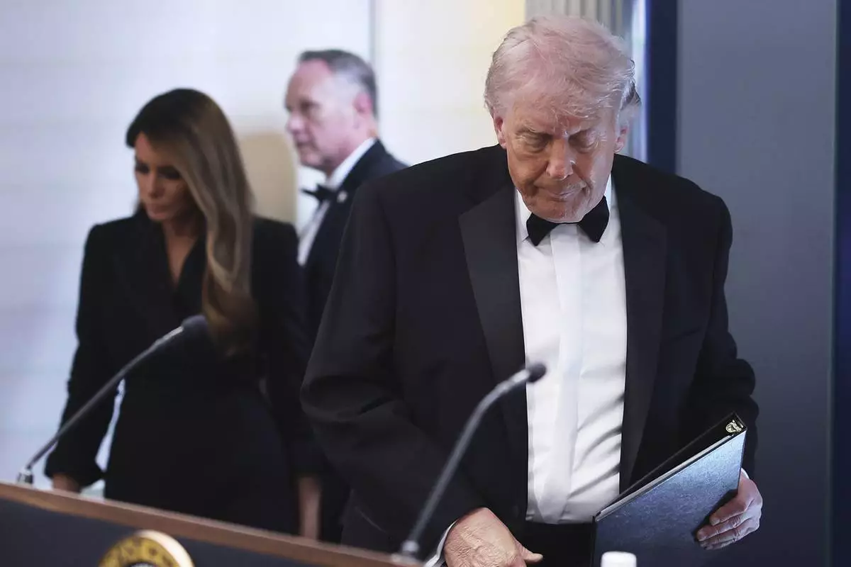 President Donald Trump and first lady Melania Trump, left, arrive at the James Brady Press Briefing Room at the White House after an unspecified threat at the annual White House Correspondents' Association Dinner in Washington, Saturday, April 25, 2026. (AP Photo/Tom Brenner)