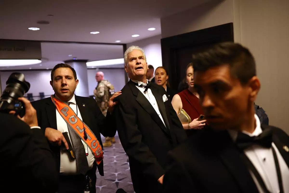 Law enforcement responds during an incident at the White House Correspondents Dinner, Saturday, April 25, 2026, in Washington. (AP Photo/Tom Brenner)