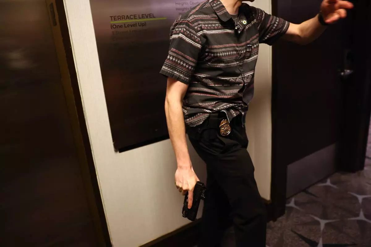 Law enforcement responds during an incident at the White House Correspondents Dinner, Saturday, April 25, 2026, in Washington. (AP Photo/Tom Brenner)