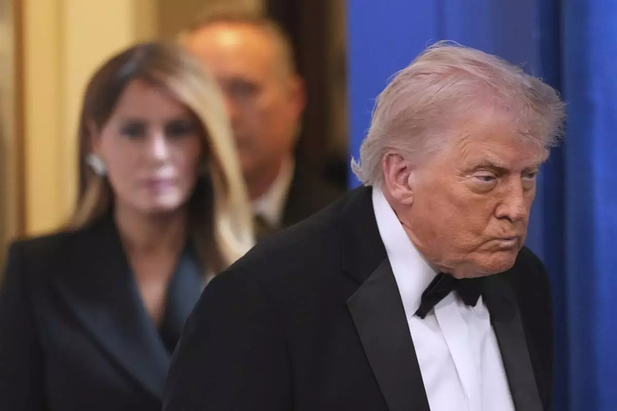 President Donald Trump with first lady Melania Trump, walks in to speak in the James Brady Press Briefing Room at the White House after an unspecified threat at the annual White House Correspondents' Association Dinner in Washington, Saturday, April 25, 2026. (AP Photo/Alex Brandon)
