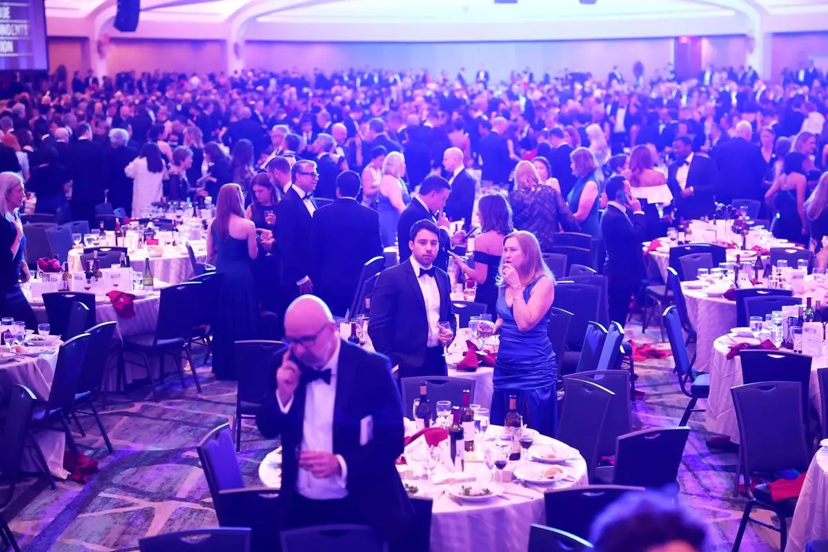 Guests begin to exit during the White House Correspondents Dinner, Saturday, April 25, 2026, in Washington. (AP Photo/Tom Brenner)