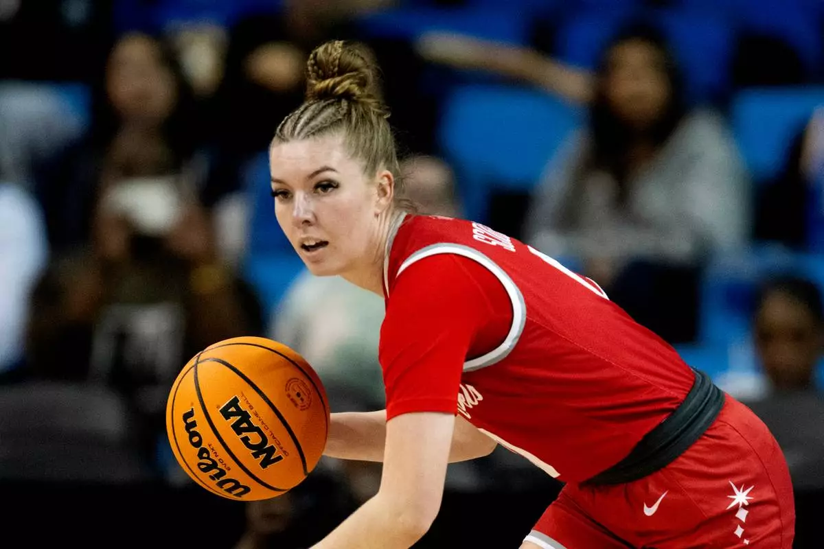 FILE - UNLV guard Ashley Scoggin (0) dribbles during an NCAA basketball game against Creighton, March 23, 2024, in Los Angeles. (AP Photo/Kyusung Gong, file)