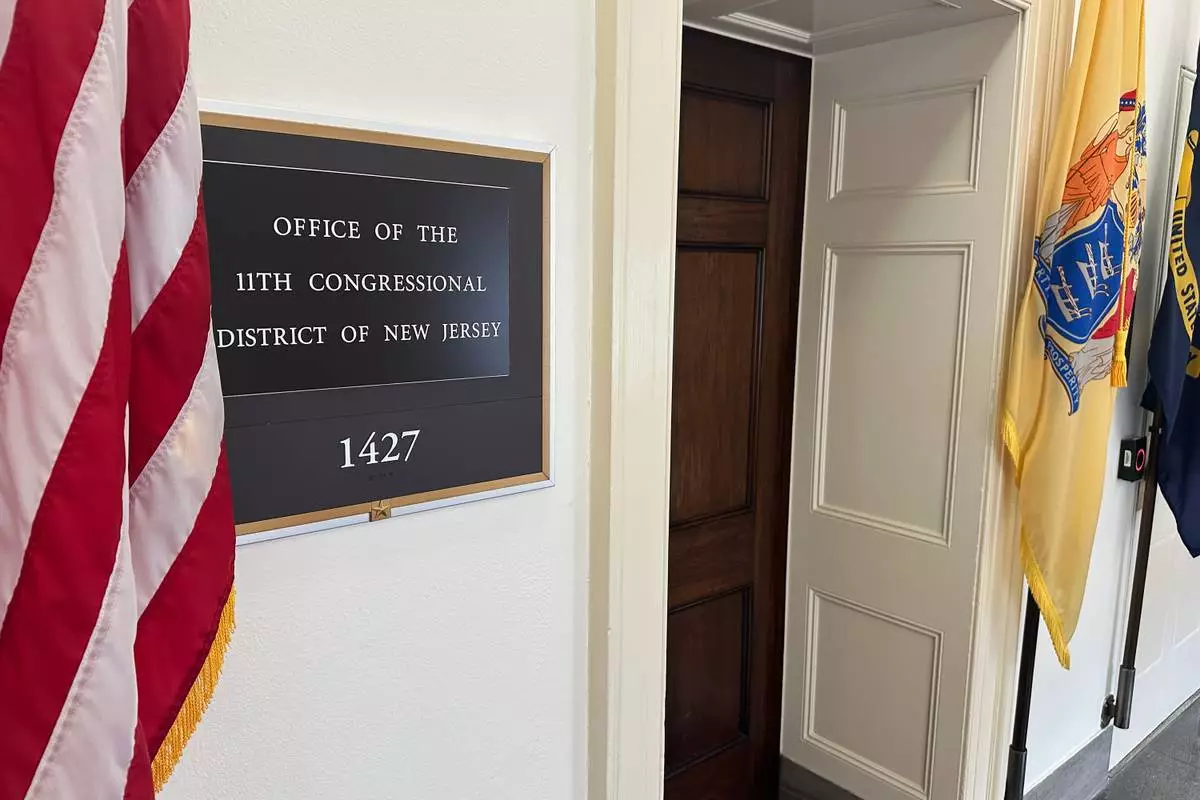 An American flag hangs outside the Office of the 11th Congressional District in the Longworth House Office Building in Washington on Thursday, April 2, 2026. (AP Photo/Robert Yoon)