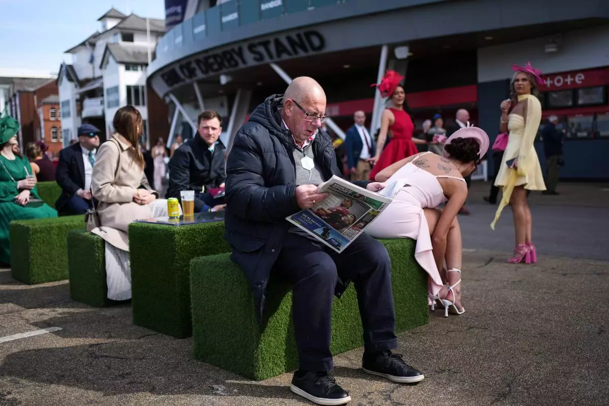 Racegoers attend Ladies Day, the second day of the Grand National Horse Racing festival, at Aintree racecourse, near Liverpool, England, Friday, April 10, 2026. (AP Photo/Jon Super)