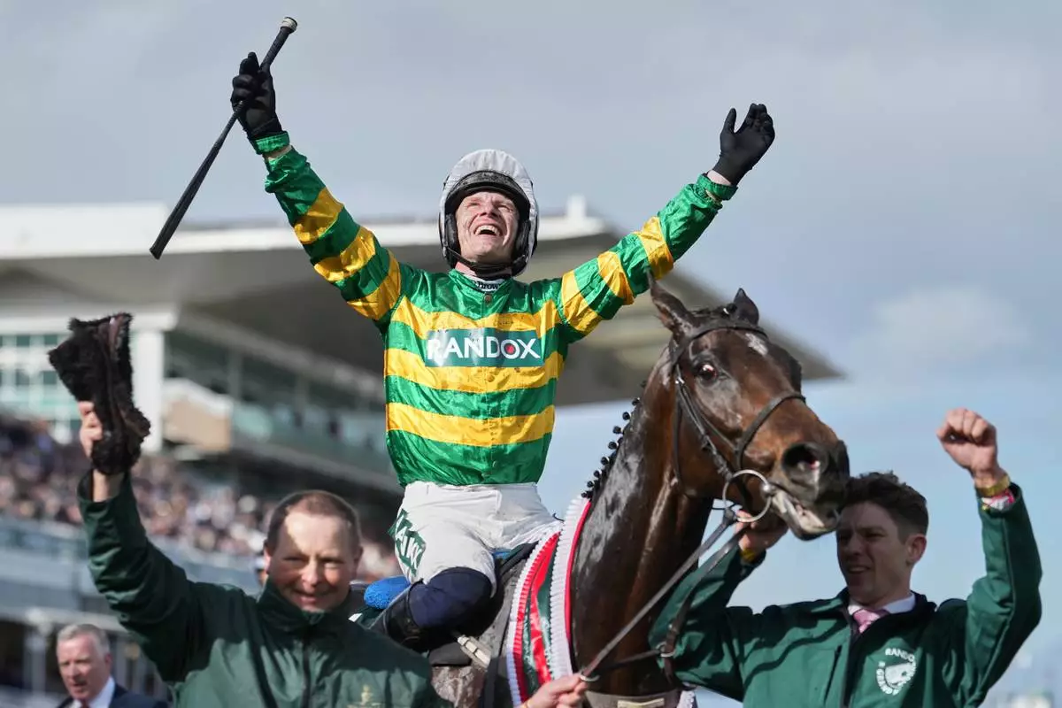 Jockey Paul Townend celebrates on I Am Maximus after winning the Grand National horse race at Aintree racecourse in Liverpool, Saturday, April 11, 2026. (AP Photo/Jon Super)
