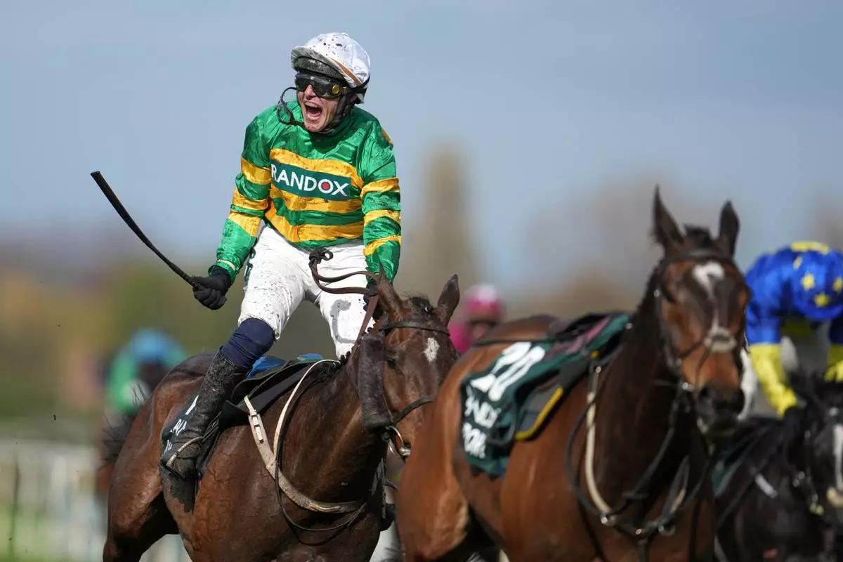 Jockey Paul Townend celebrates on I Am Maximus after winning the Grand National horse race at Aintree racecourse in Liverpool, Saturday, April 11, 2026. (AP Photo/Jon Super)