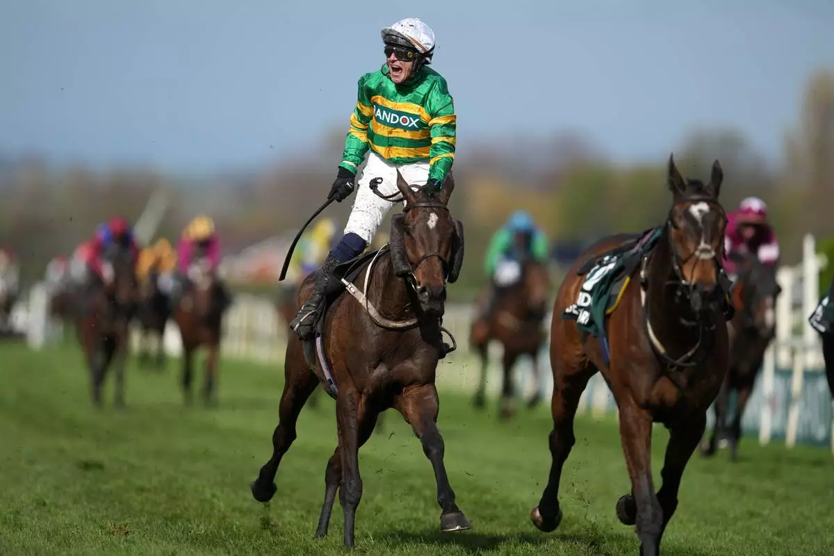 Jockey Paul Townend celebrates on I Am Maximus after winning the Grand National horse race at Aintree racecourse in Liverpool, Saturday, April 11, 2026. (AP Photo/Jon Super)