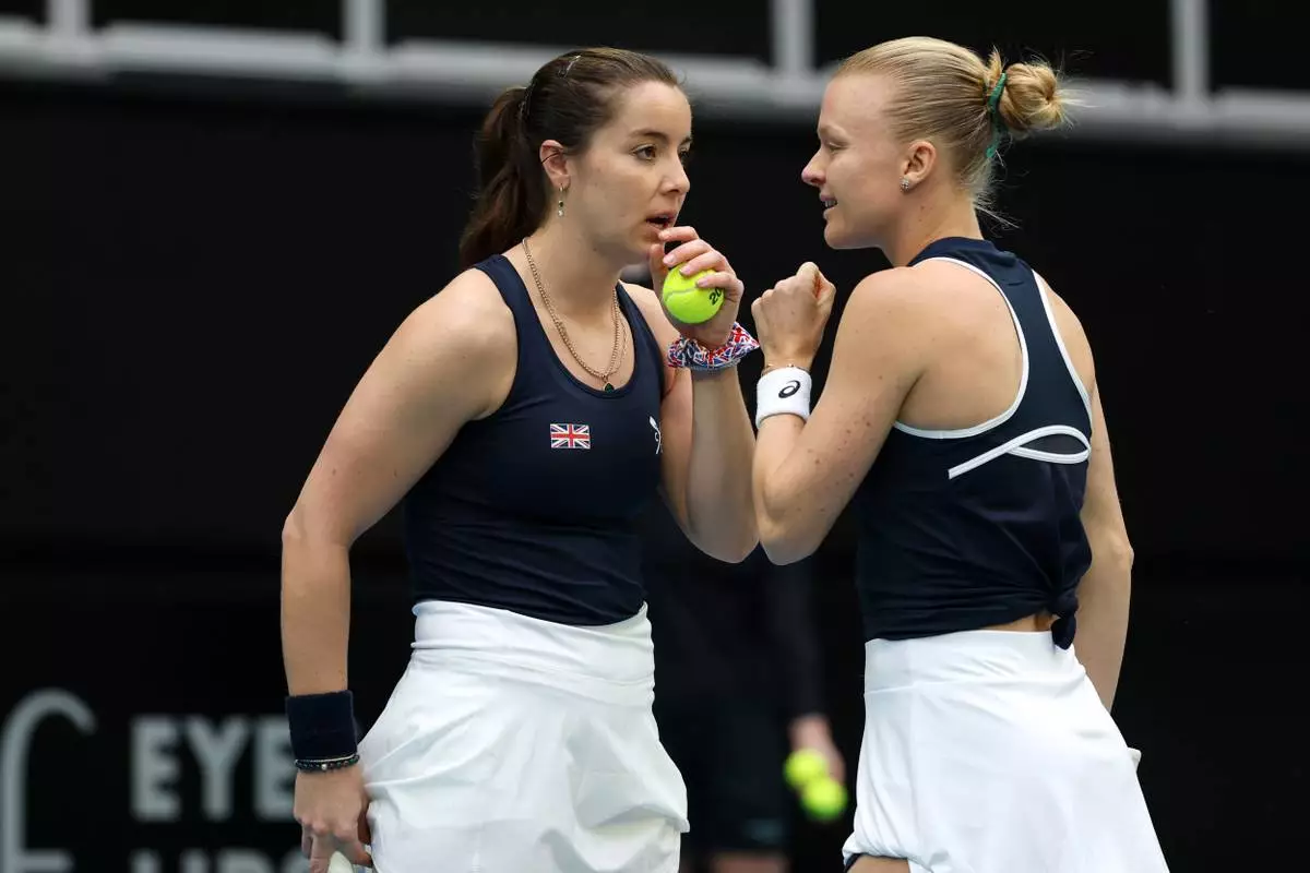 Britain's Harriet Dart and Jodie Burrage, right, talk while playing a doubles match against Australia in their Billy Jean King Cup tie in Melbourne, Saturday, April 11, 2026, (Con Chronis/AAP Image via AP)