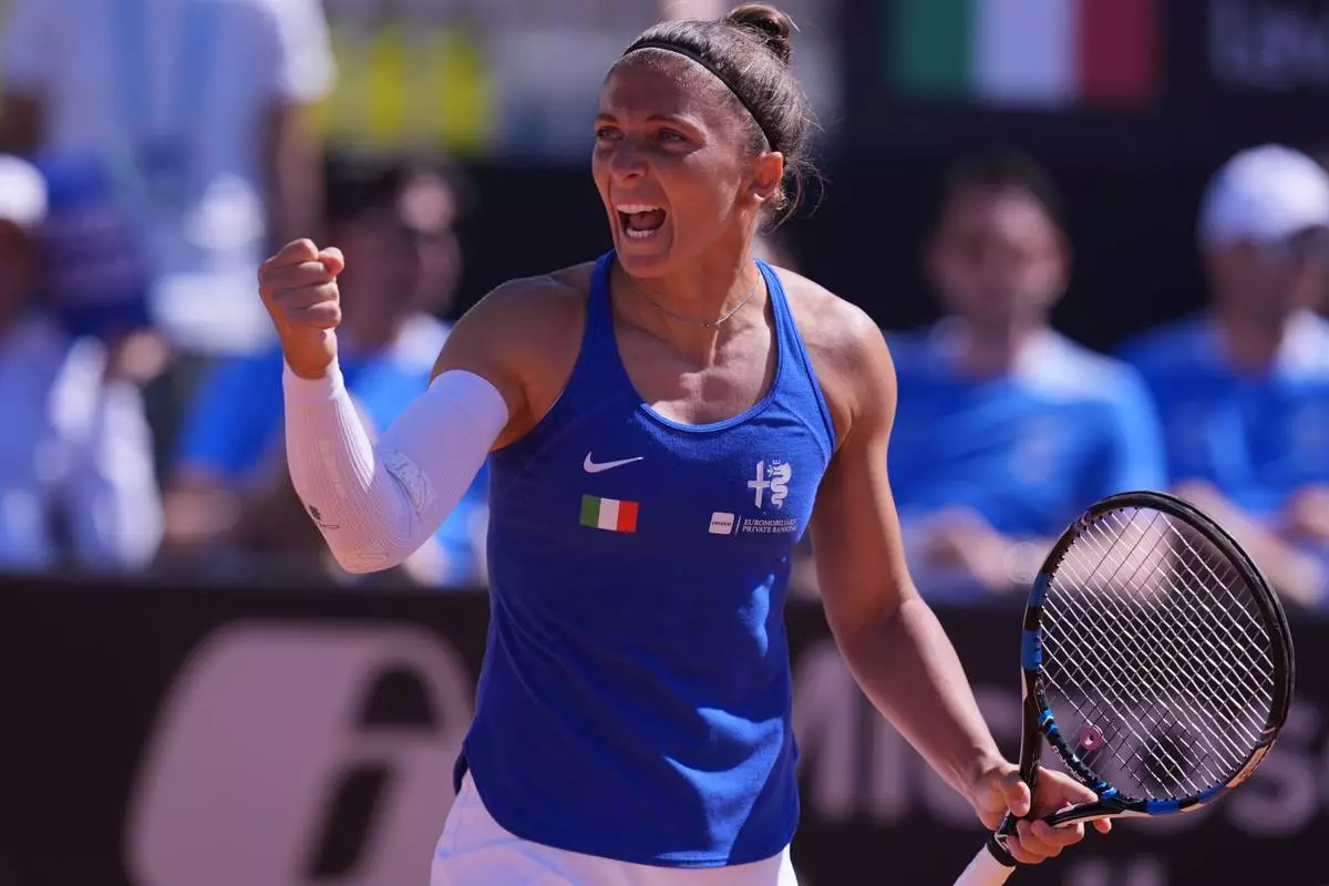 Italy's Sara Errani celebrates a point with teammate Jasmine Paolini during a Billy Jean King Cup doubles match against Japan's Eri Hozumi and Shuko Aoyama, in Velletri, Italy, Saturday, April 11, 2026. (Alfredo Falcone/LaPresse via AP)