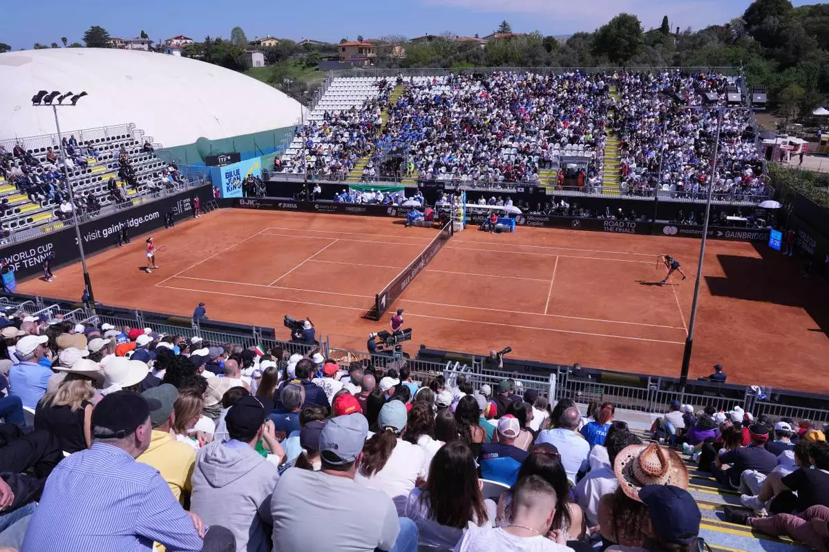 Italy's Elisabetta Cocciaretto, right, serves to Japan's Moyuka Uchijima during the Billy Jean King Cup match between Italy and Japan in Velletri, Italy, Friday April 10, 2026. (Alfredo Falcone/LaPresse via AP)