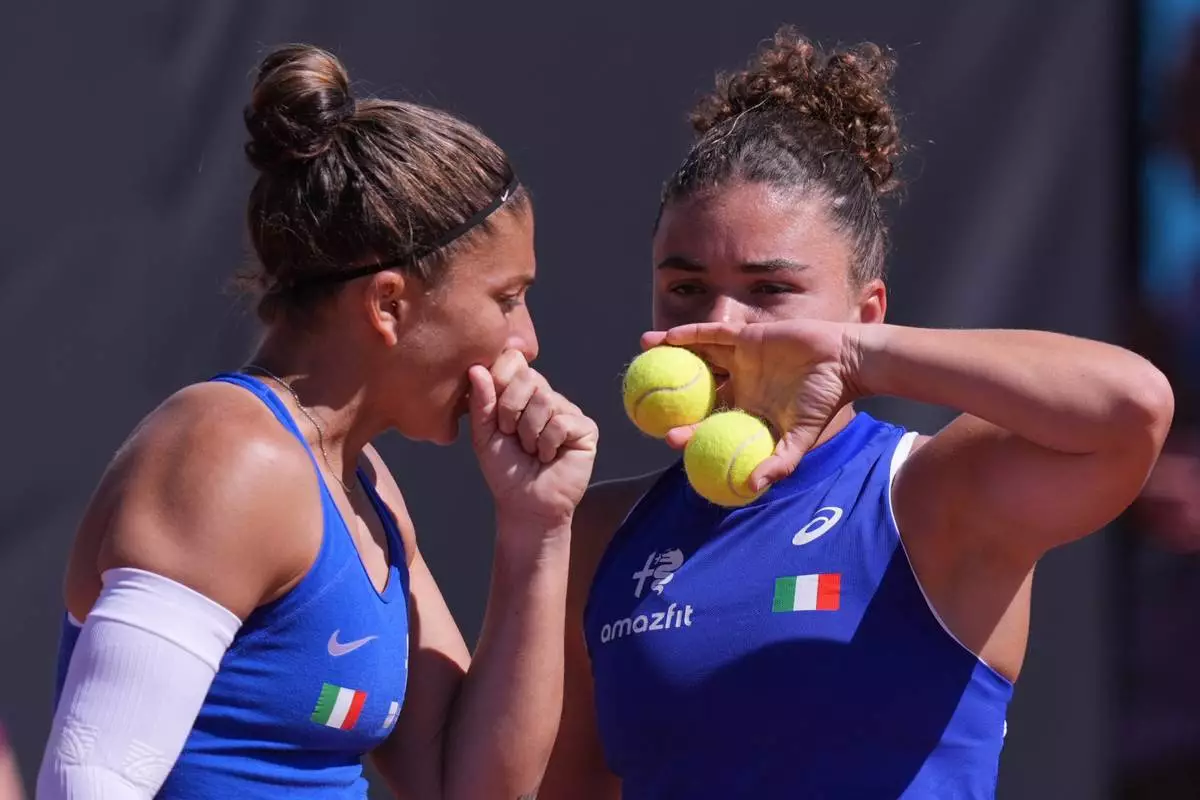 Italy's Jasmine Paolini, right, and teammate Sara Errani talk tactics during a Billy Jean King Cup doubles match between Italy and Japan, in Velletri, Italy, Saturday, April 11, 2026. (Alfredo Falcone/LaPresse via AP)