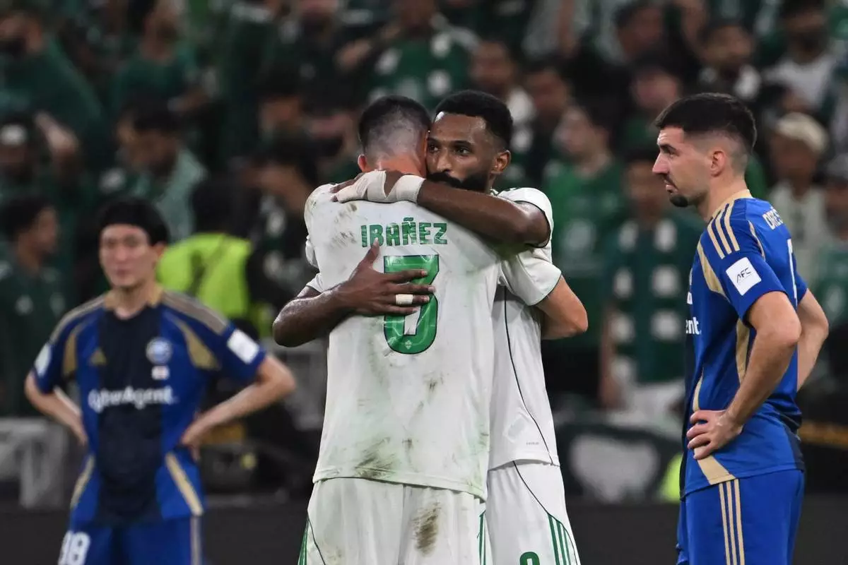 Al-Ahli's Feras Albrikan hugs his teammate Ibanez after scoring at Machida Zelvia, during the AFC Champions League Elite Final soccer match between Al-Ahli and Machida Zelvia at King Abdullah Sports City Stadium, in Jeddah, Saudi Arabia, Saturday, April 25, 2026. (AP Photo/Ali Issa)