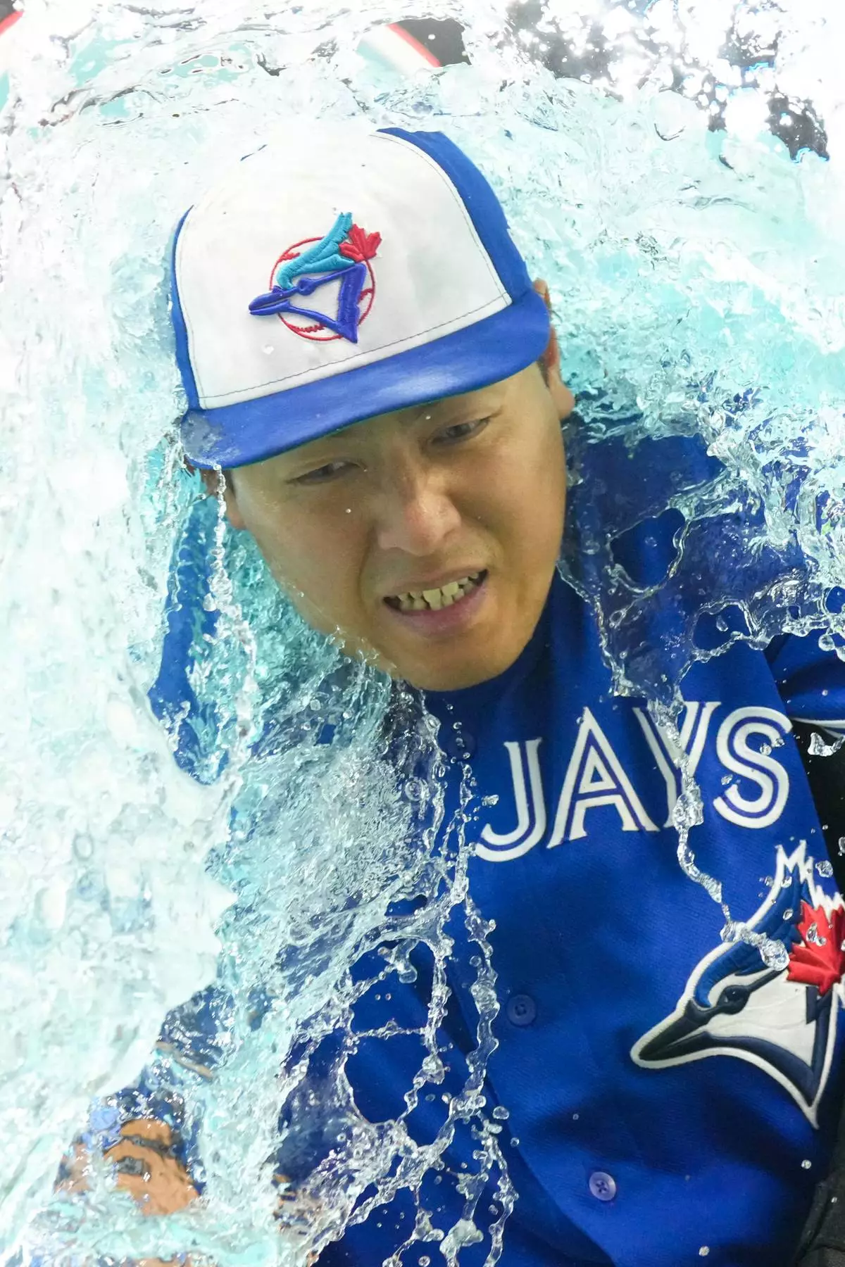Toronto Blue Jays third baseman Kazuma Okamoto gets doused by teammates after their 5-3 win over the Cleveland Guardians in a baseball game in Toronto, Saturday, April 25, 2026. (Chris Young/The Canadian Press via AP)