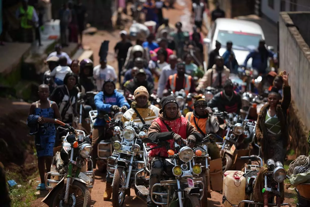 FILE - People wait for Pope Leo XIV in Bamenda, Cameroon, Thursday, April 16, 2026, on the fourth day of his 11-day pastoral visit to Africa. (AP Photo/Andrew Medichini, File)