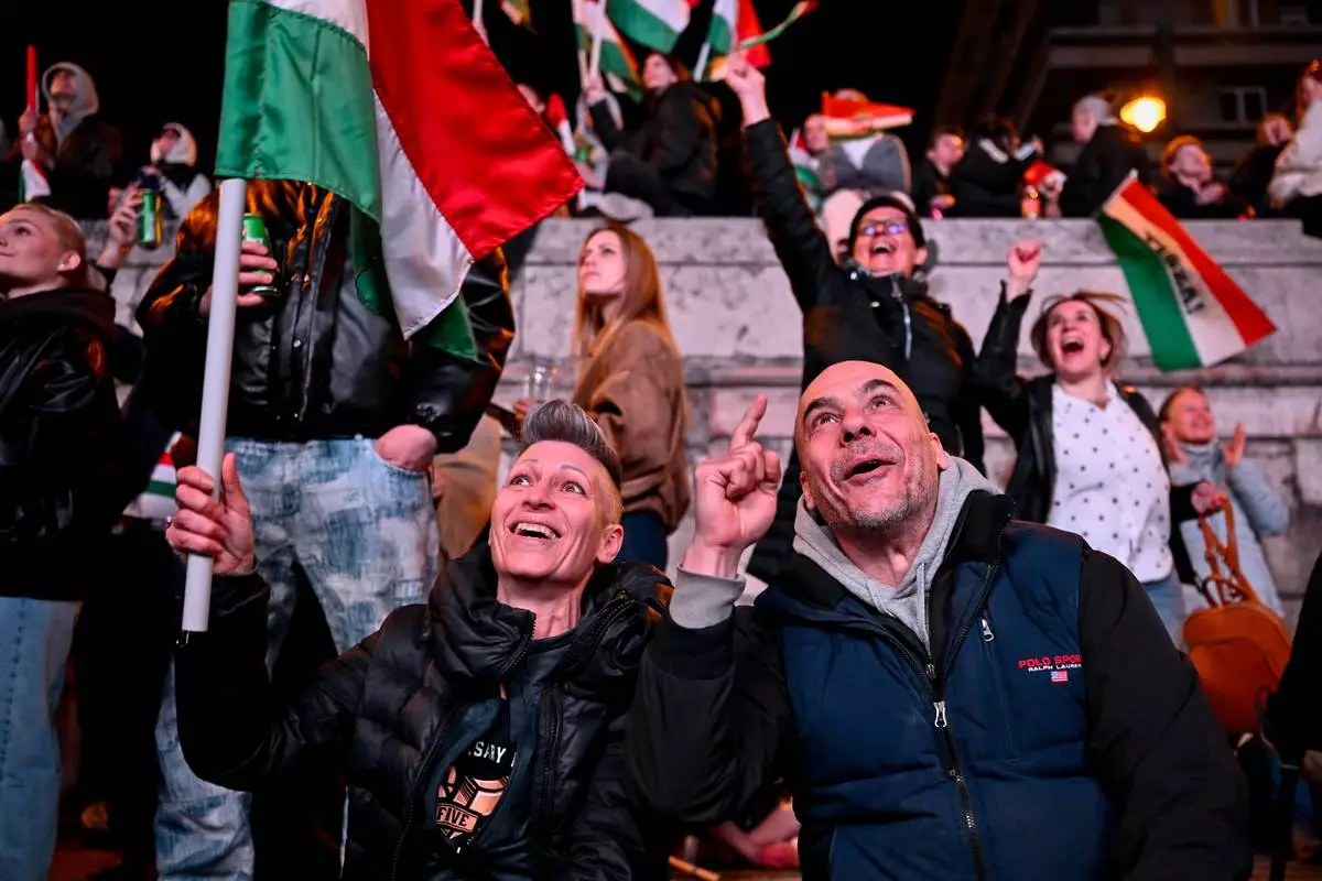 FILE - People react in the streets after the announcement of partial results of the Hungarian parliamentary in Budapest, Hungary, Sunday, April 12, 2026. (AP Photo/Denes Erdos, File)