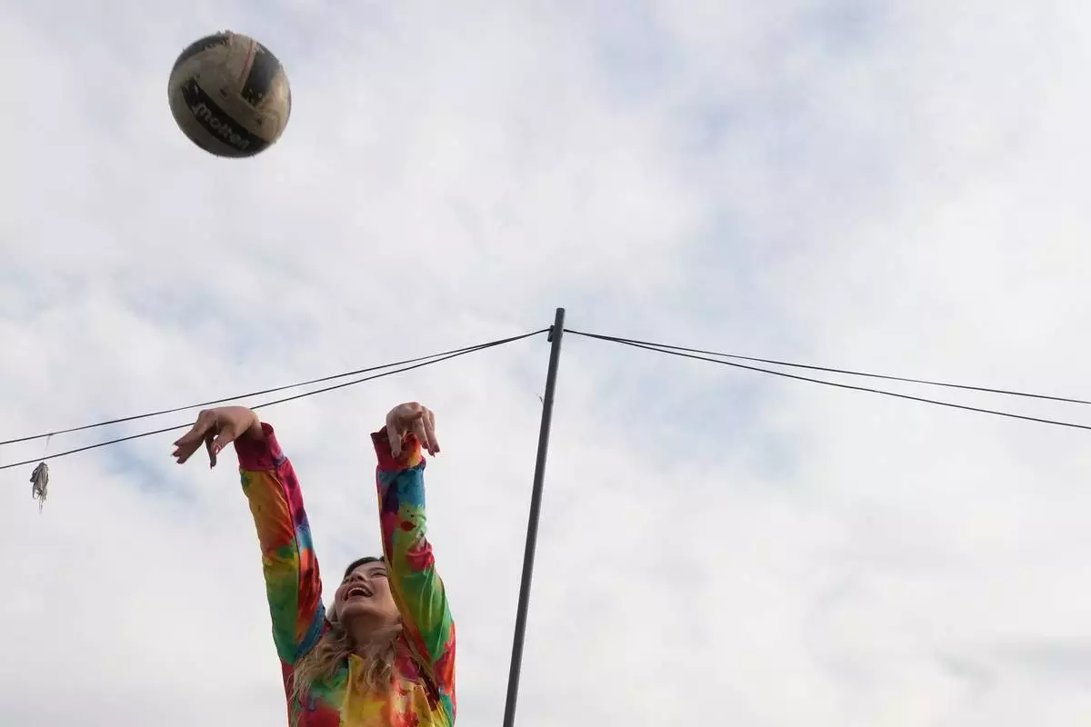 FILE - A woman plays volleyball at Pardisan Park in Tehran, Iran, Friday, April 10, 2026. (AP Photo/Vahid Salemi, File)