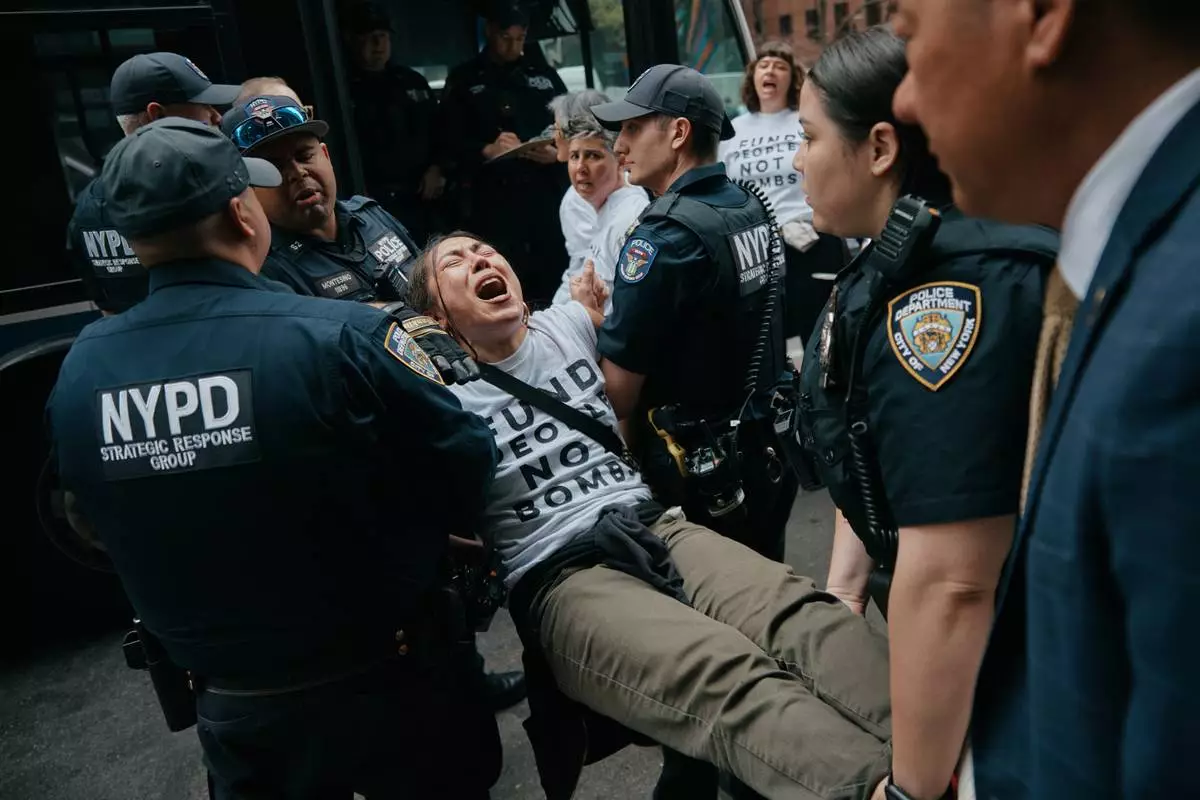 FILE - Protesters with Jewish Voice for Peace get arrested after blocking traffic during a demonstration outside the New York office of U.S. Sen. Chuck Schumer, calling for an end to the U.S.-Israel war with Iran and opposing U.S. weapons support on Monday, April 13, 2026, in New York. (AP Photo/Andres Kudacki, File)