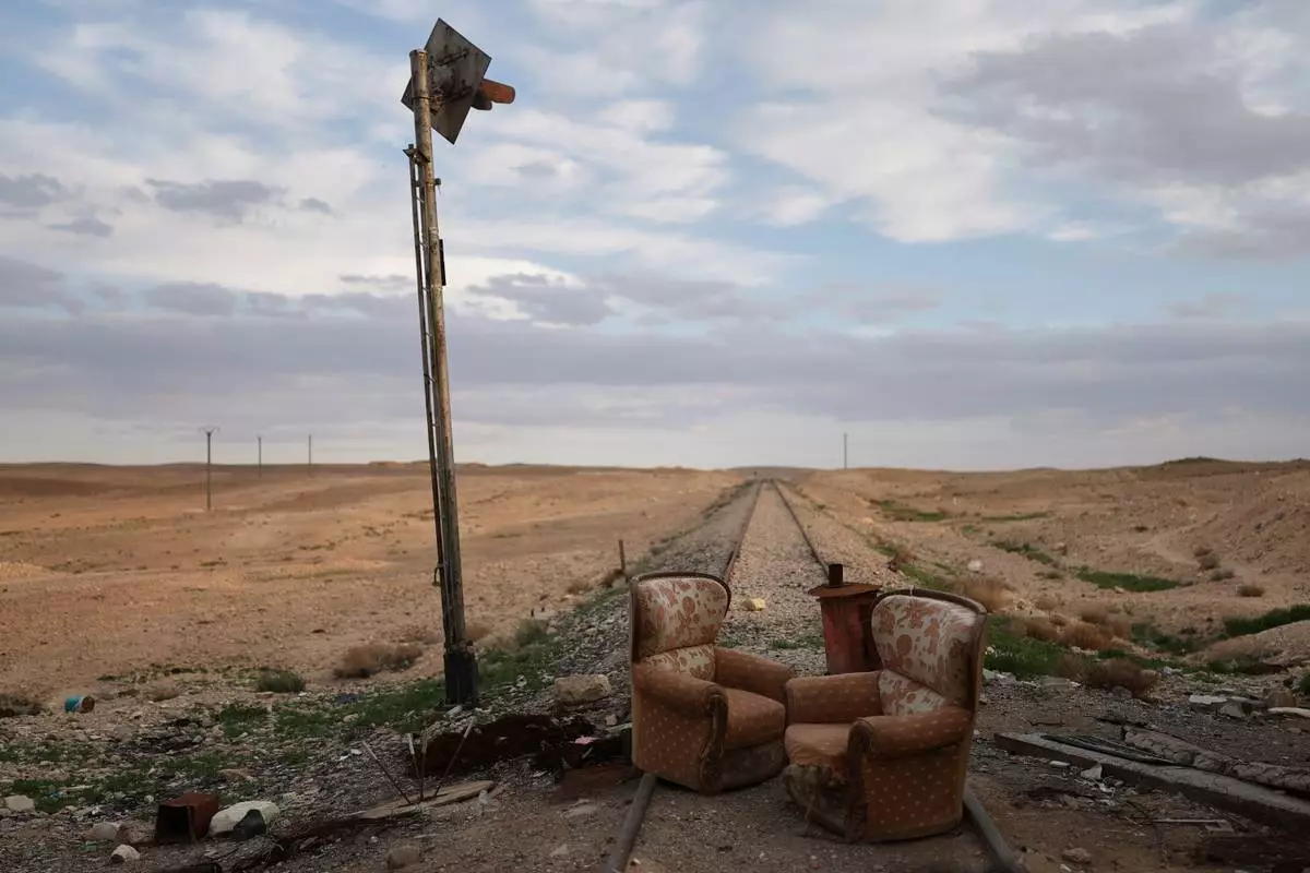 FILE - Two armchairs sit at an abandoned railway crossing used as a checkpoint by the Assad regime's Syrian army, east of Homs, Syria, Saturday, April 11, 2026. (AP Photo/Ghaith Alsayed, File)