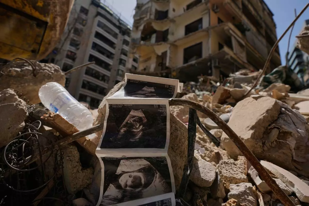 FILE - Sonogram images of a baby lie among the rubble of a destroyed building that was hit a week ago in an Israeli airstrike, in central Beirut, Lebanon, Thursday, April 16, 2026. (AP Photo/Hussein Malla, File)