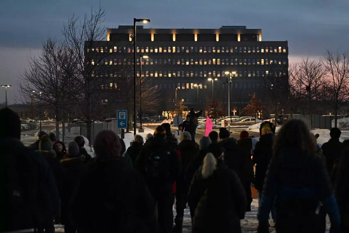 FILE - Protesters gather outside the Bishop Henry Whipple Federal Building, Jan. 8, 2026, in Minneapolis, Minn. (AP Photo/Tom Baker, File)