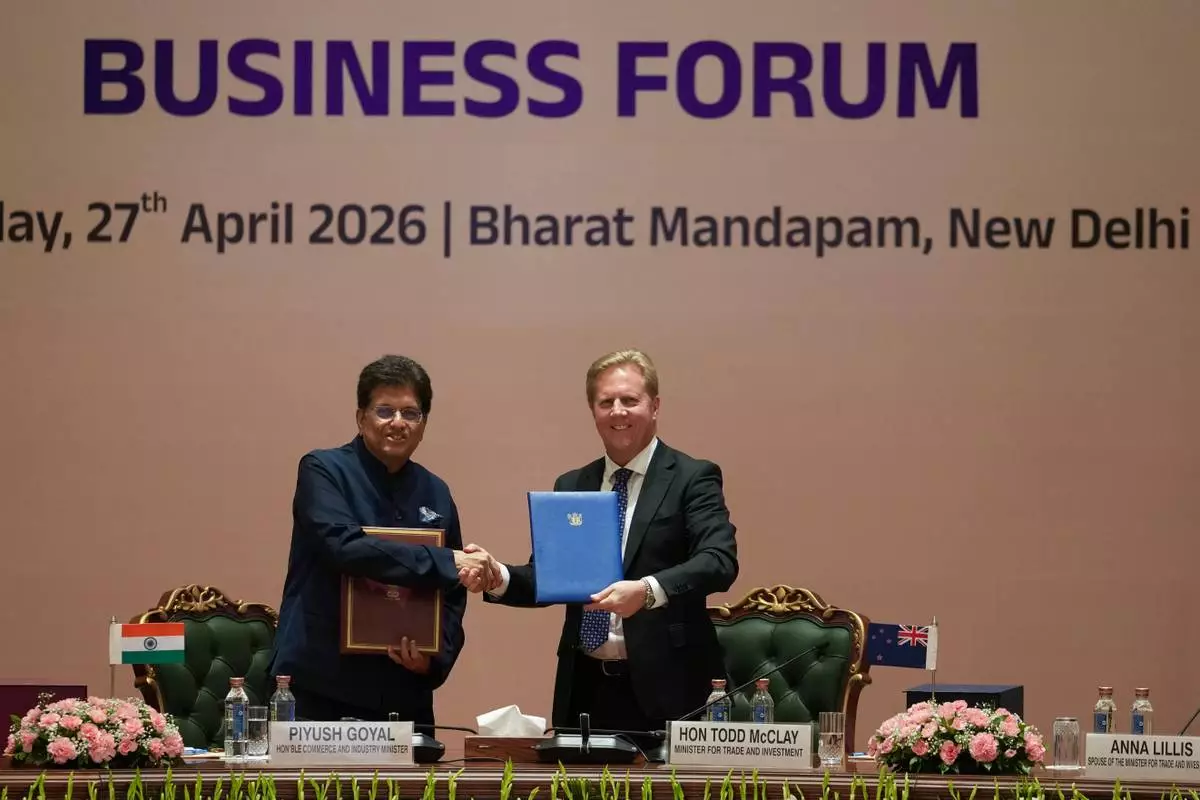 Todd McClay, New Zealand Minister for Trade and Investment shakes hand with Indian Commerce Minister Piyush Goyal following the India New Zealand Free Trade Agreement signing ceremony and Business forum meeting in New Delhi, India, Monday, April 27, 2026. ( AP Photo/Manish Swarup)