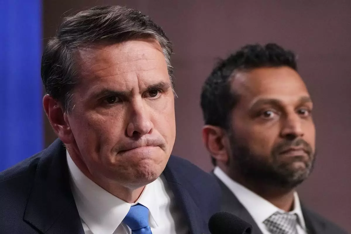 Acting Attorney General Todd Blanche speaks as FBI Director Kash Patel listens during a news conference at the Justice Department, Tuesday, April 21, 2026, in Washington. (AP Photo/Jacquelyn Martin)