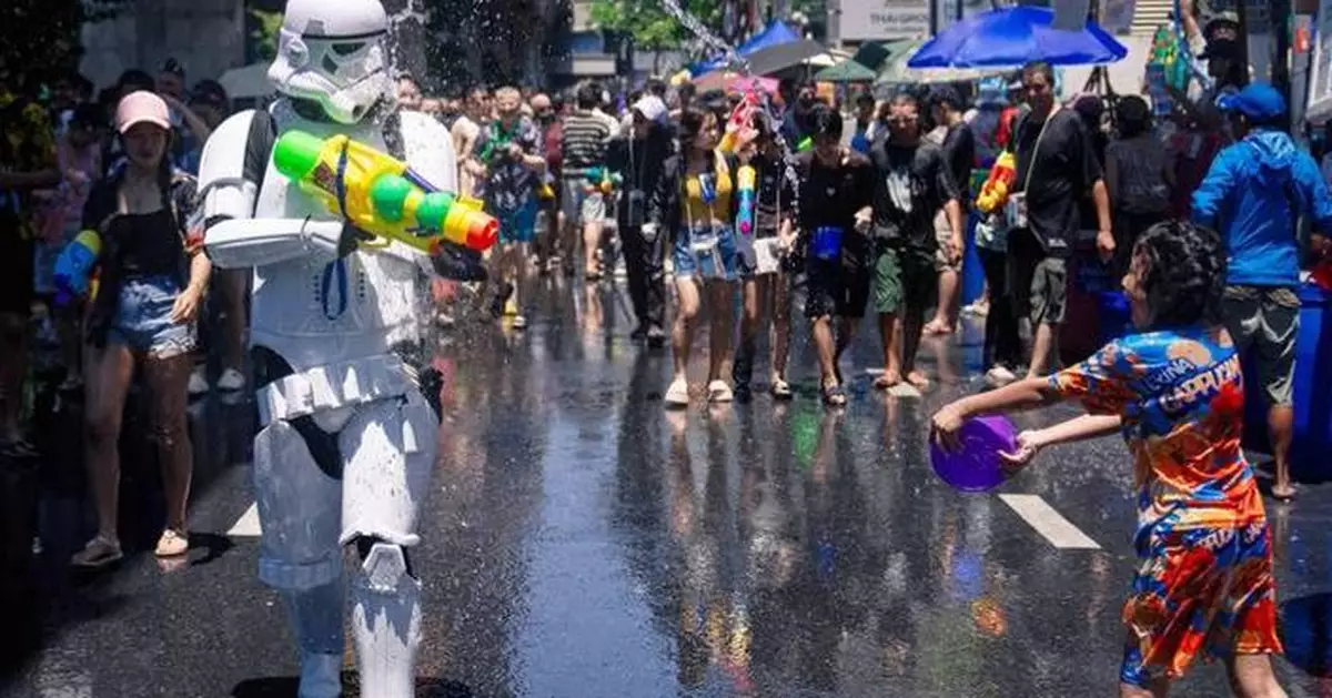 People spray water to celebrate the Thai New Year during the Songkran festival, in photos