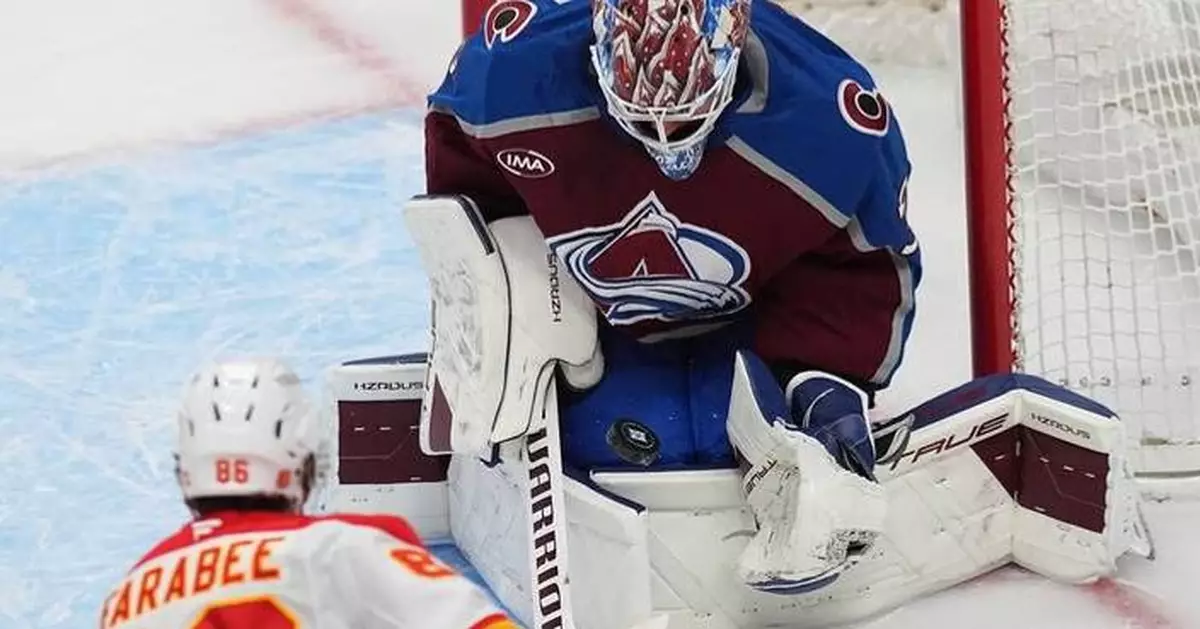 MacKinnon scores career-high 52nd goal of season, Avs clinch NHL's top seed with 3-1 win over Flames