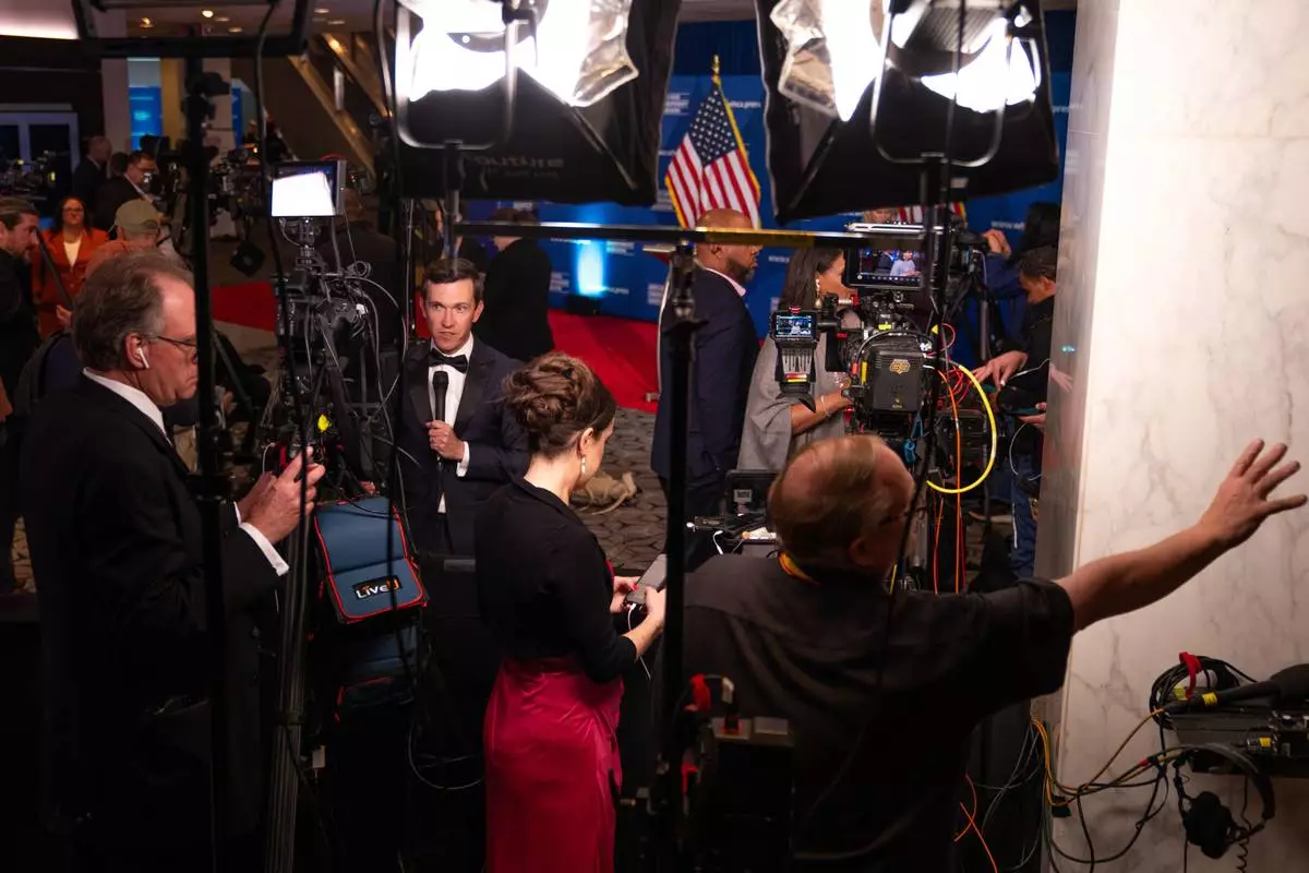 Journalists that were in attendance for the White House Correspondents Dinner work following a press briefing at the Washington Hilton following an incident that disrupted the event, Saturday, April 25, 2026, in Washington. (AP Photo/Allison Robbert)