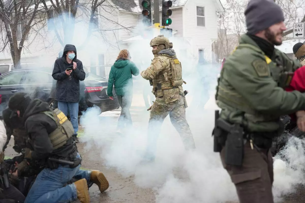 FILE - Tear gas is deployed as federal agents make arrests, Jan. 21, 2026, in Minneapolis. (AP Photo/Angelina Katsanis, File)
