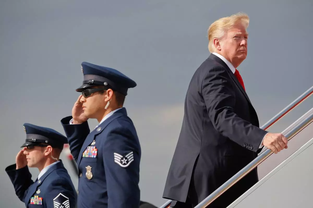 FILE - President Donald Trump boards Air Force One during his departure from Andrews Air Force One Base, Md., April 28, 2018. Trump traveled to Michigan to speak at a rally on the same night as the White House Correspondent's Dinner, the second straight year Trump as skipped the event with the White House Press Corps. (AP Photo/Pablo Martinez Monsivais, File)