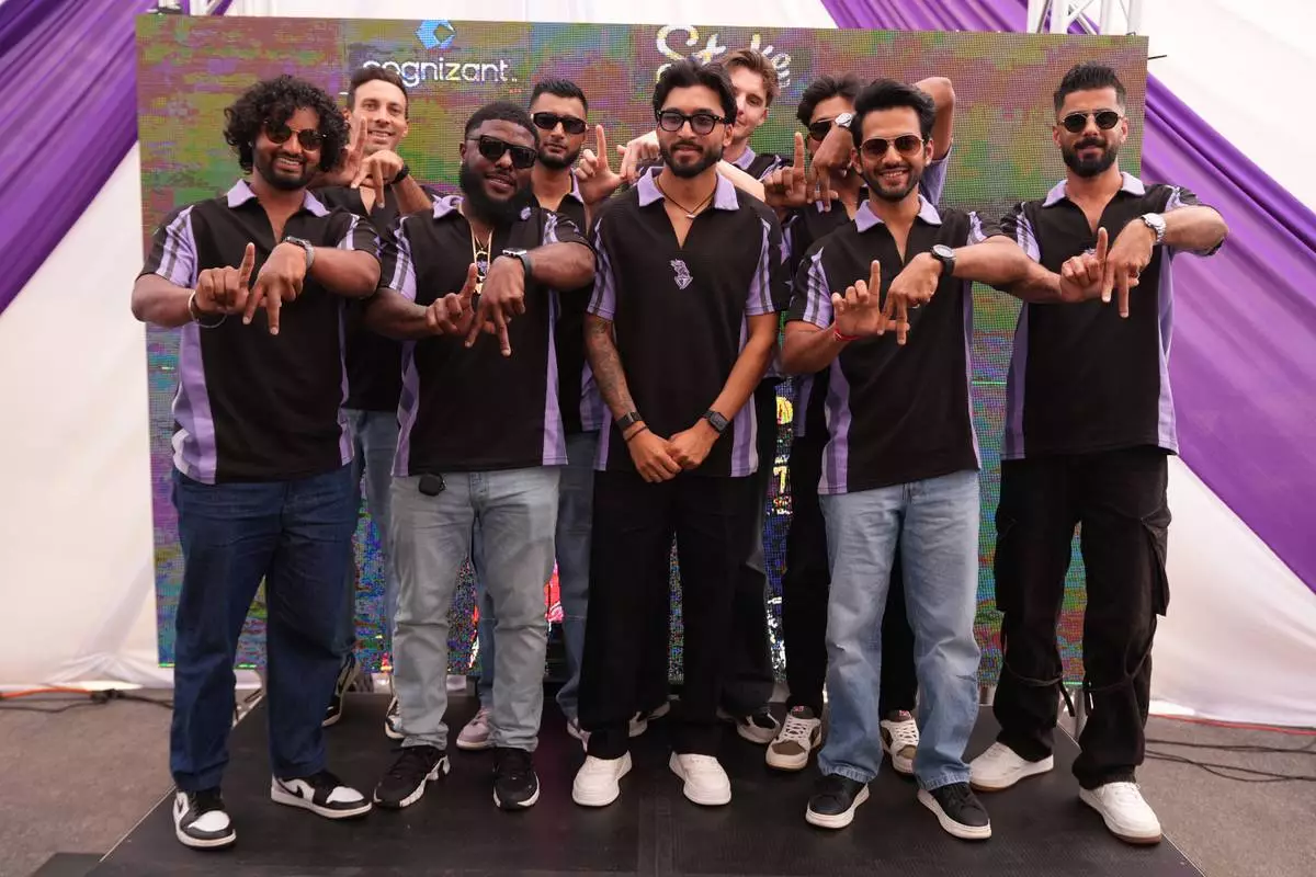 Members of the Los Angeles Knight Riders, cricket team form a LA sign with their hands as they pose for a picture at the Pomona Fairplex on Wednesday, April 22, 2026, during the groundbreaking ceremony of the new Knight Riders Cricket Field, which will serve as the Los Angeles Knight Riders' official home field for 2026 and later host cricket at the LA 2028 Olympics. (AP Photo/Damian Dovarganes)