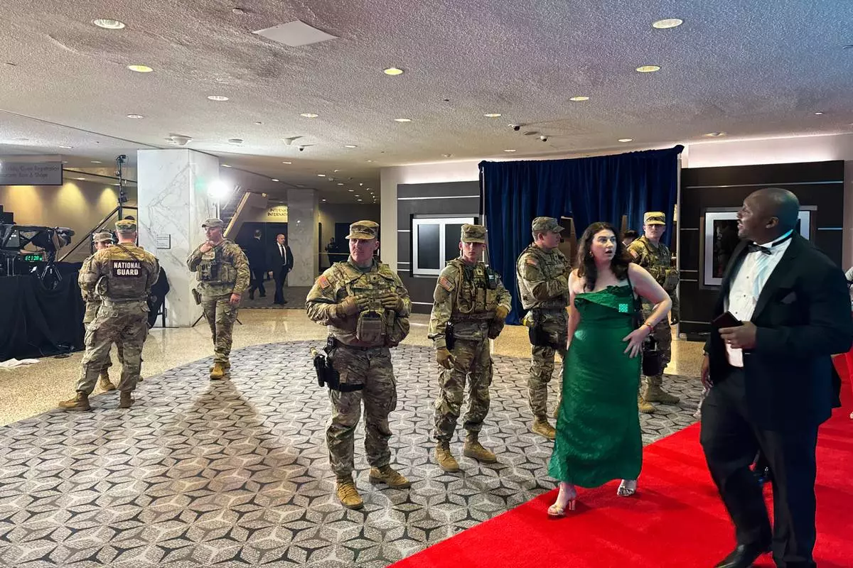 The National Guard respond to an incident at the White House Correspondents Dinner, Saturday, April 25, 2026, in Washington. (AP Photo/Mark Schiefelbein)