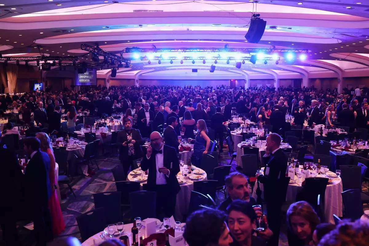 Guest evacuate after an incident at the White House Correspondents Dinner, Saturday, April 25, 2026, in Washington. (AP Photo/Tom Brenner)
