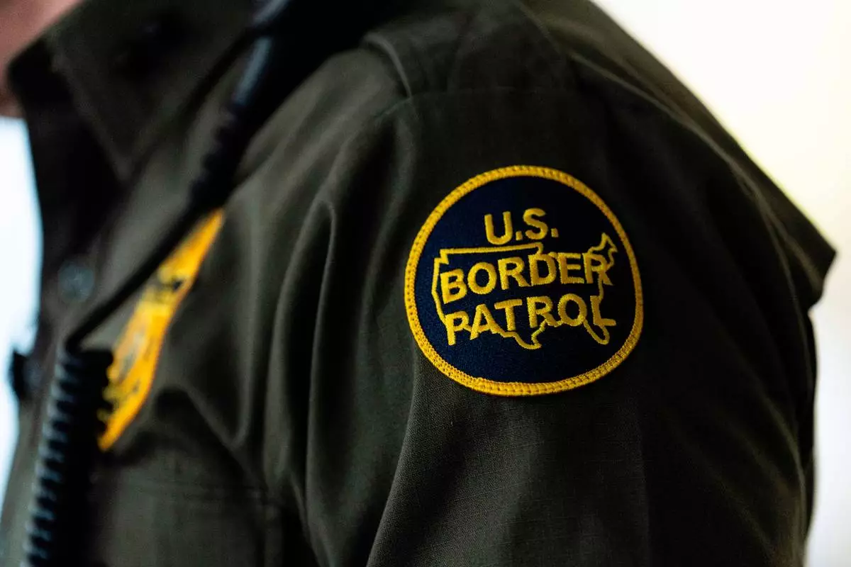 FILE - A U.S Border Patrol badge is displayed as Gregory Bovino, chief patrol agent of the U.S. Border Patrol's El Centro Sector, stands in a conference room before an interview with The Associated Press in Los Angeles, Aug. 25, 2025. (AP Photo/Jae C. Hong, File)
