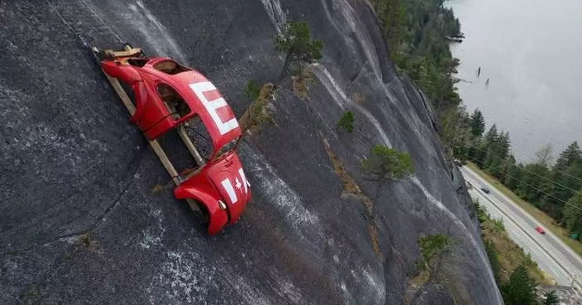 Car shell suspended on rock face above British Columbia highway in apparent prank