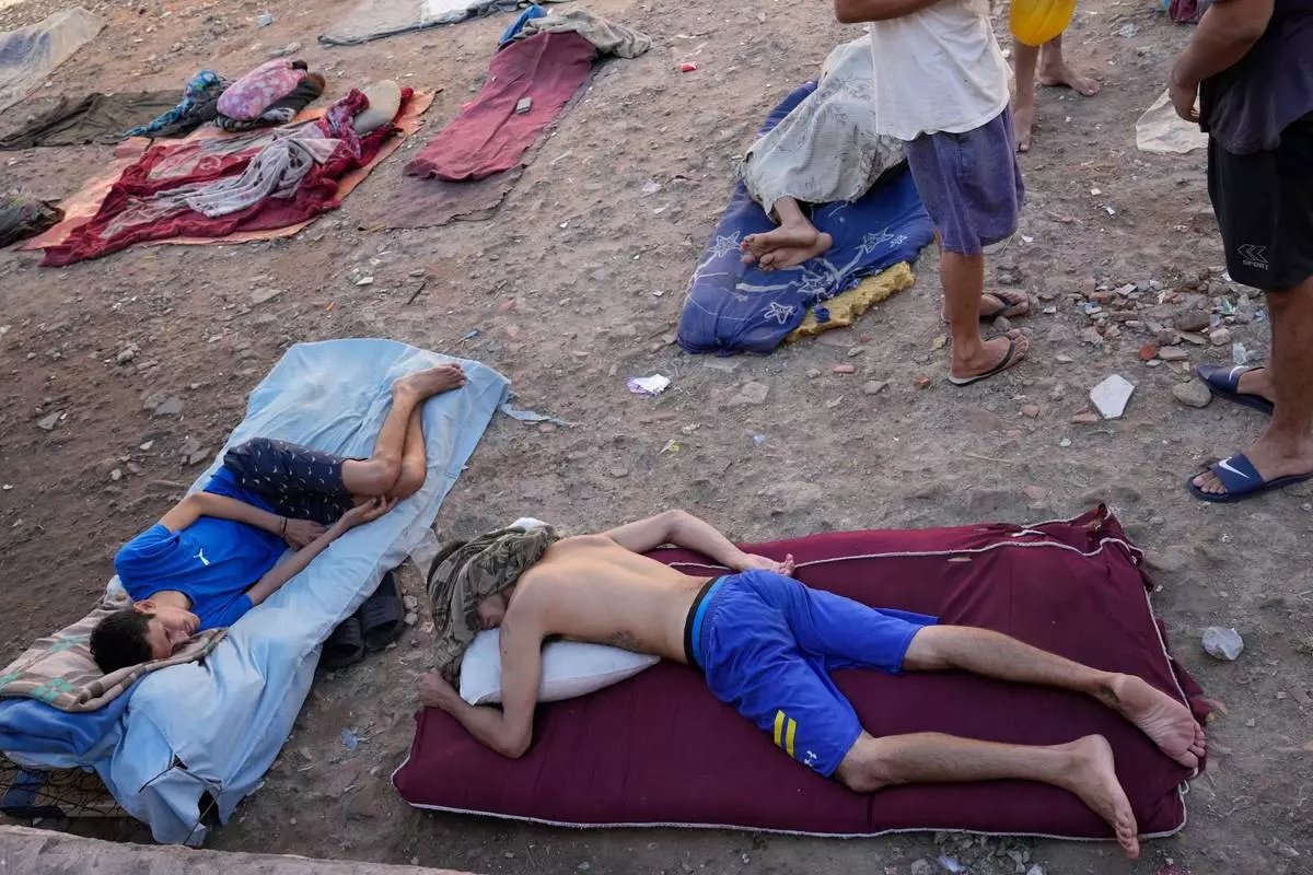 FILE - Inmates sleep outdoors due to lack of indoor space at the Tacumbu prison in Asuncion, Paraguay, March 31, 2026. (AP Photo/Jorge Saenz, File)
