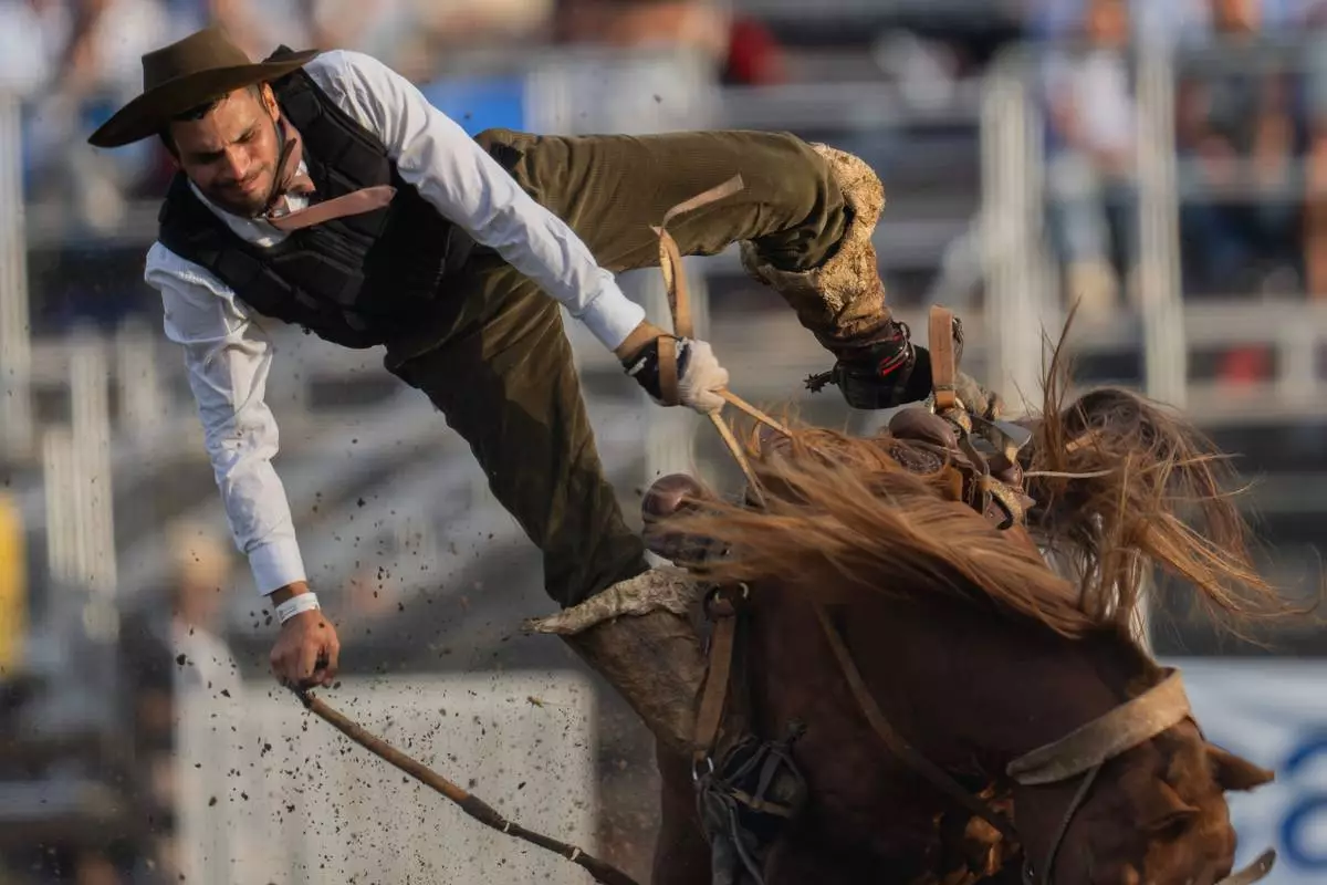 FILE - A "gaucho," or cowboy, rides a horse during the Criolla Week rodeo festival, an annual festival held during Holy Week, in Montevideo, Uruguay, April 2, 2026. (AP Photo/Matilde Campodonico, File)