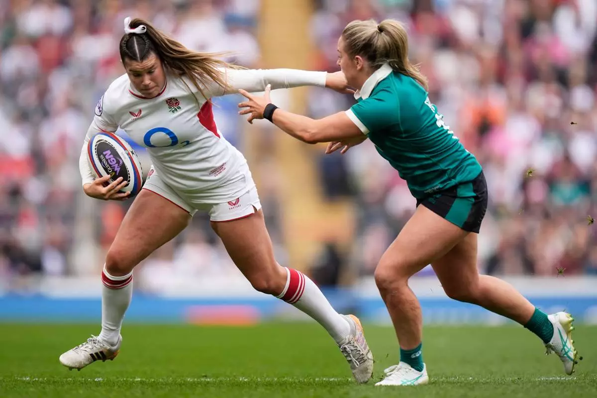 England's Jess Breach, left, and Ireland's Stacey Flood in action during the Women's Six Nations Rugby 2026 match, in London, Saturday, April 11, 2026. (Andrew Matthews/PA via AP)