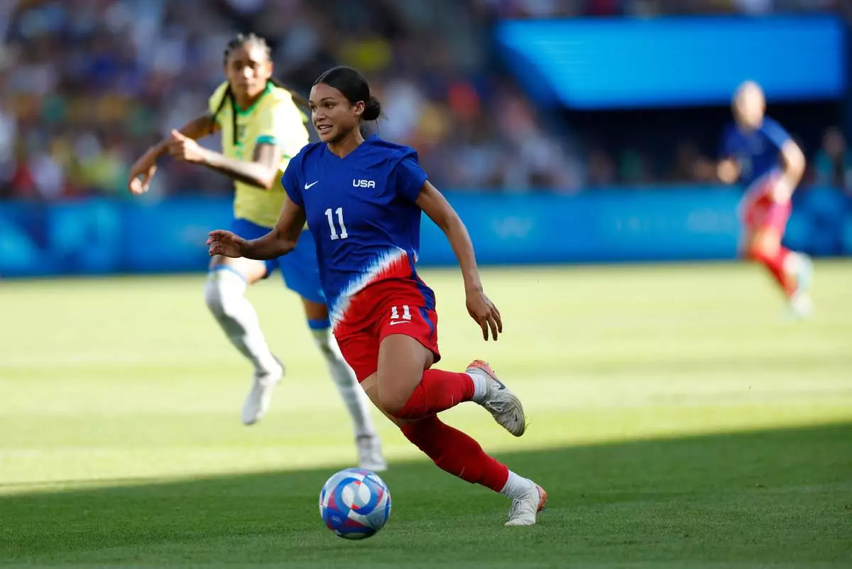 FILE - Sophia Smith of the United States runs with the ball during the women's soccer gold medal match between Brazil and the United States at the Parc des Princes during the 2024 Summer Olympics in Paris, Aug. 10, 2024. (AP Photo/Aurelien Morissard, File)