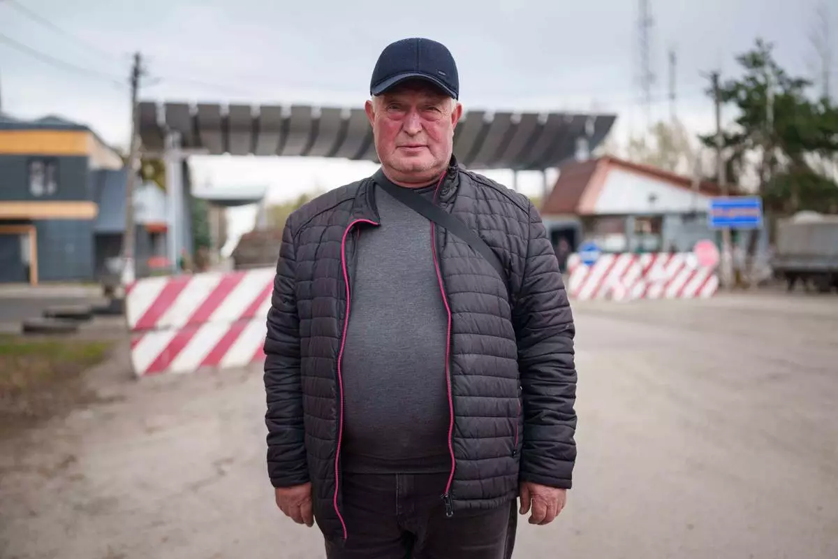 Serhii Buriak, 60, who helped guard abandoned buildings after the 1986 Chernobyl nuclear accident, poses for a portrait near the plant in Chernobyl, Ukraine, Tuesday, April 21, 2026. (AP Photo/Evgeniy Maloletka)