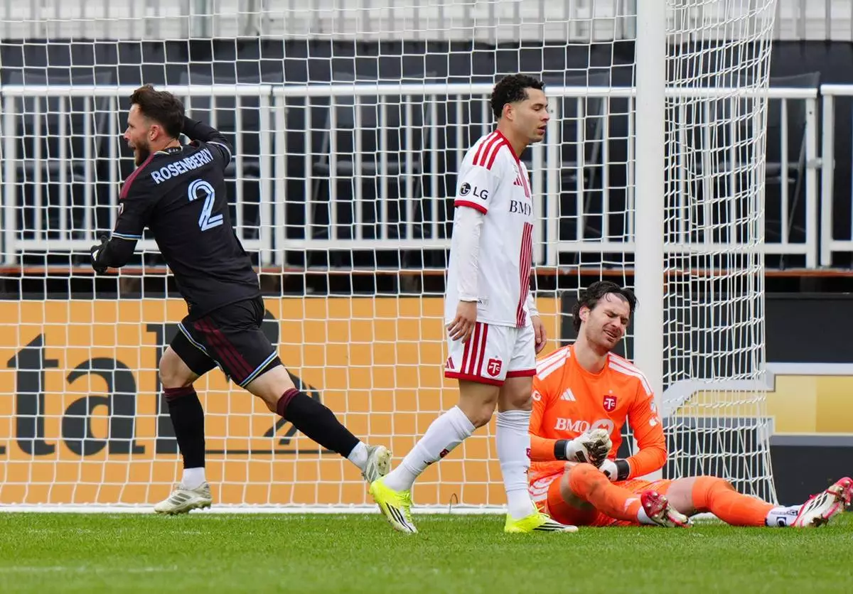 Colorado Rapids defender Keegan Rosenberry (2) celebrates his goal as Toronto FC defender Matheus Pereira and FC goalkeeper Luka Gavran (1) react during the second half of an MLS soccer game in Toronto, Saturday, April 4, 2026. (Frank Gunn/The Canadian Press via AP)