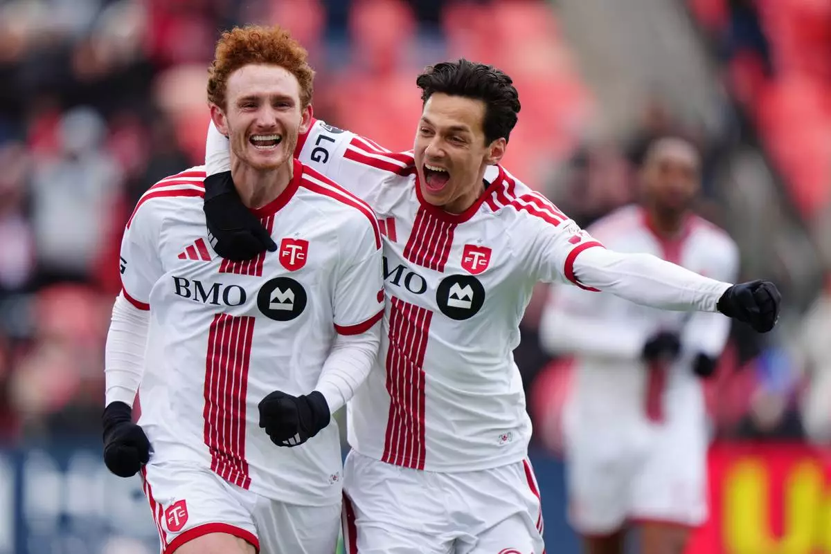 Toronto FC forward Josh Sargent, left, celebrates with Richie Laryea after scoring a goal agians the Colorado Rapids during the second half of an MLS soccer game in Toronto, Saturday, April 4, 2026. (Frank Gunn/The Canadian Press via AP)