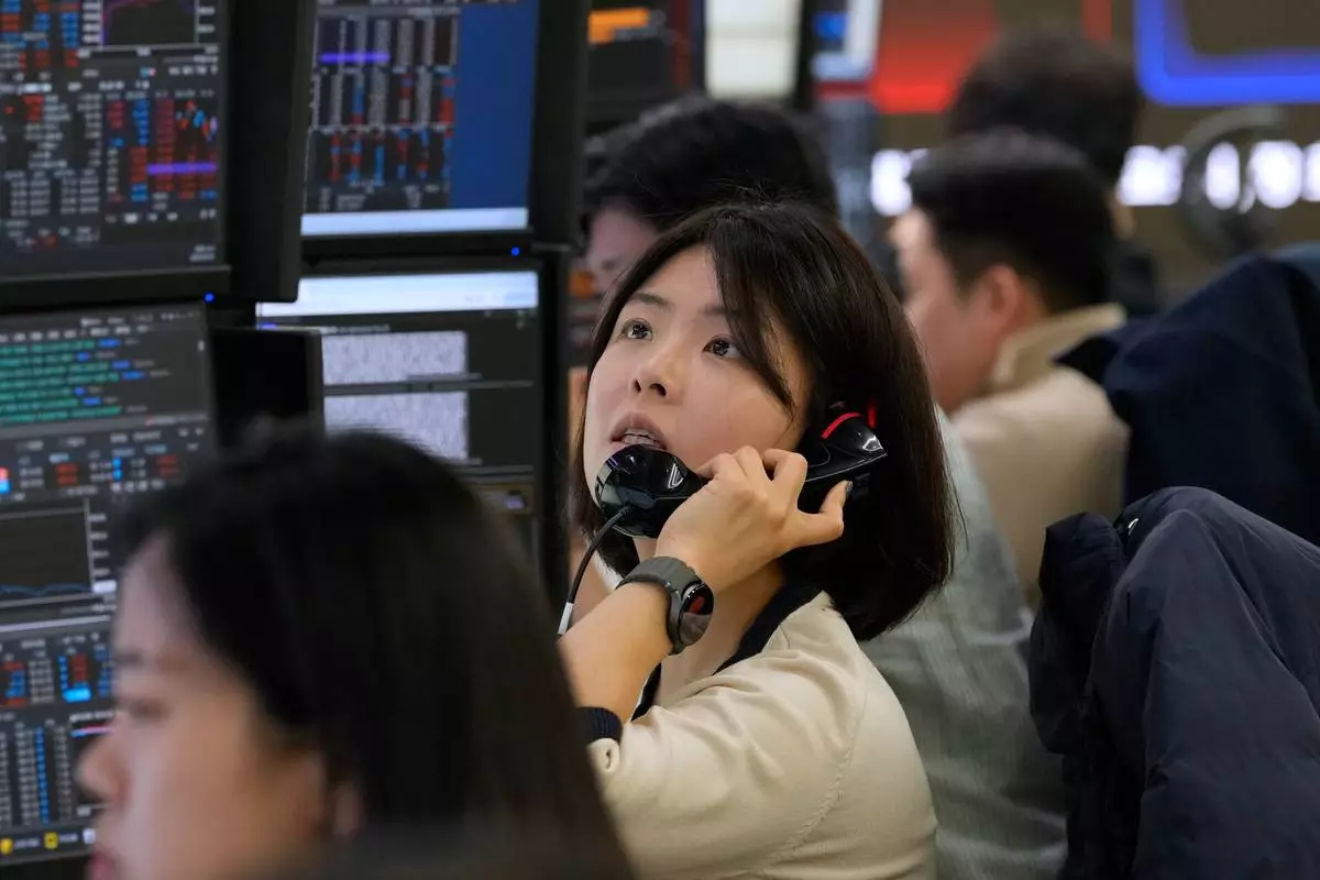 A currency trader talks on the phone at the foreign exchange dealing room of the Hana Bank headquarters in Seoul, South Korea, Friday, April 3, 2026. (AP Photo/Ahn Young-joon)