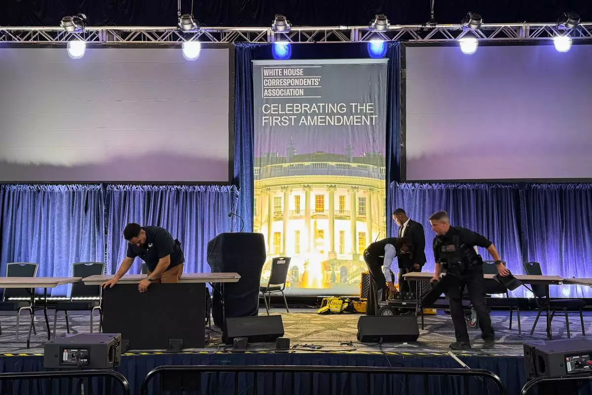 Staff clean up after a shooting incident at the White House Correspondents Dinner, Saturday, April 25, 2026, in Washington. (AP Photo/Mark Schiefelbein)