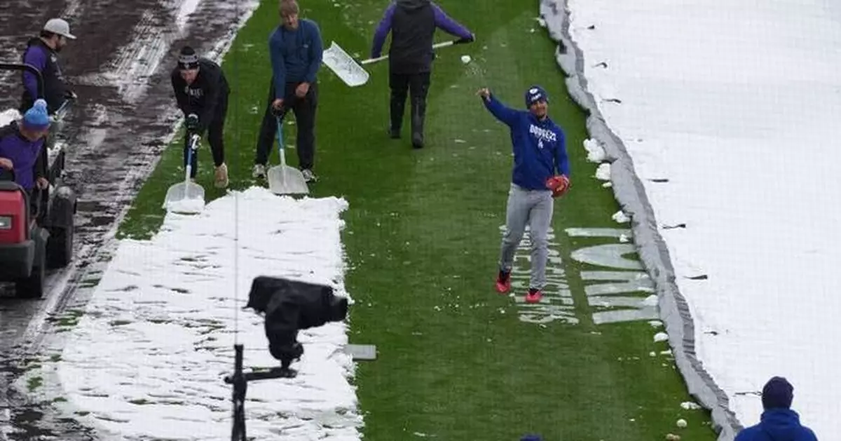 A mid-April snowstorm coats Coors Field as Dodgers-Rockies series gets off to frosty start