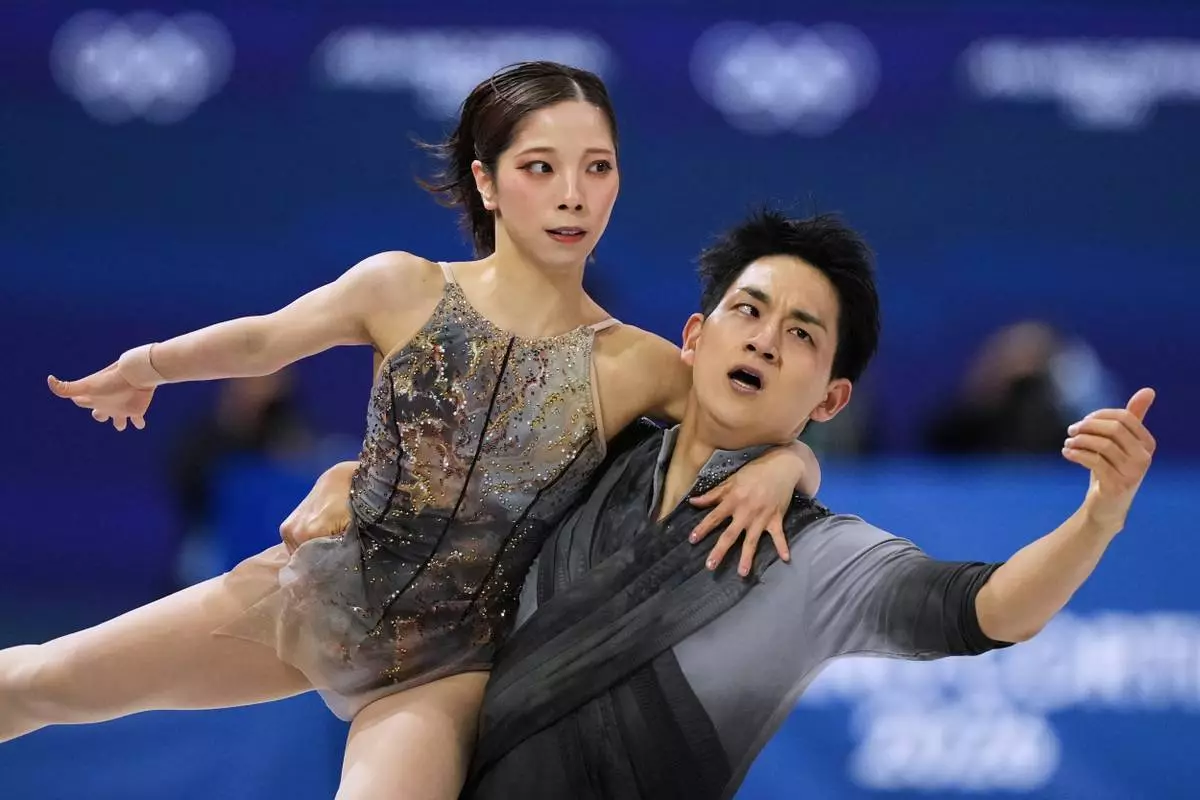 FILE -Riku Miura and Ryuichi Kihara of Japan compete during the pairs figure skating long program at the 2026 Winter Olympics, in Milan, Italy, Monday, Feb. 16, 2026. (AP Photo/Francisco Seco, File)